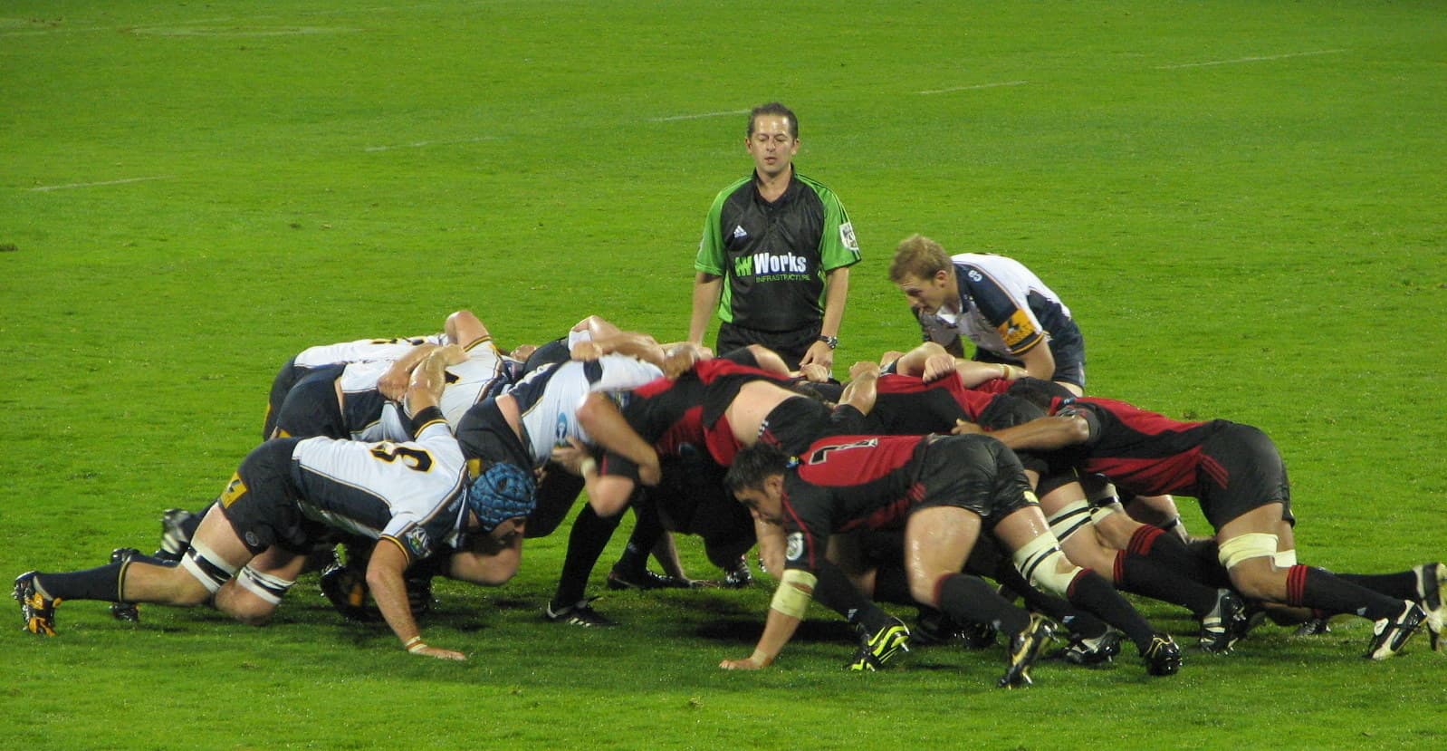 Rugby union scrum contested by two packs