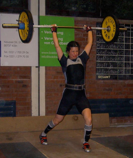 Weightlifter receiving a clean