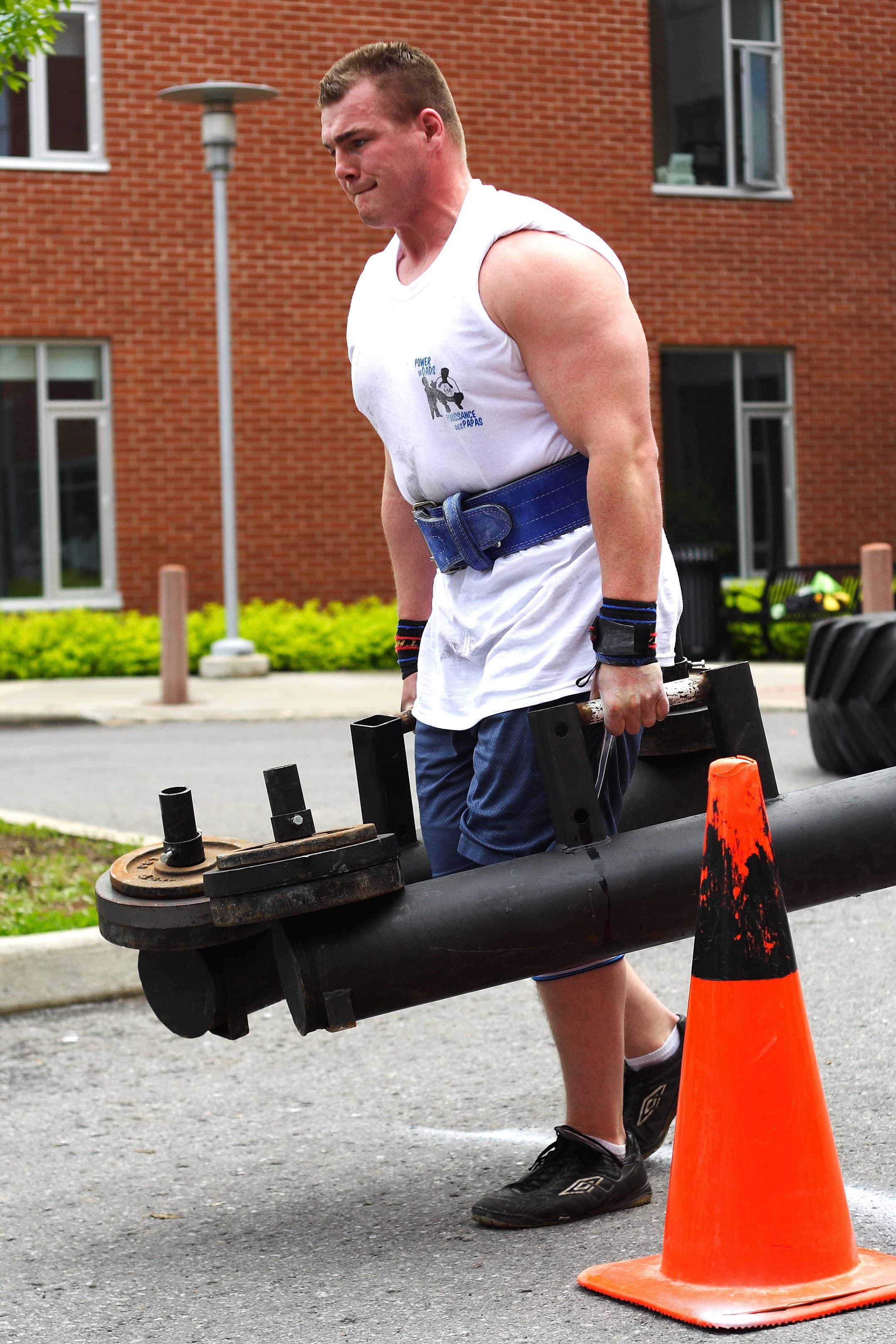 Strongman training event with heavy farmer carry implements